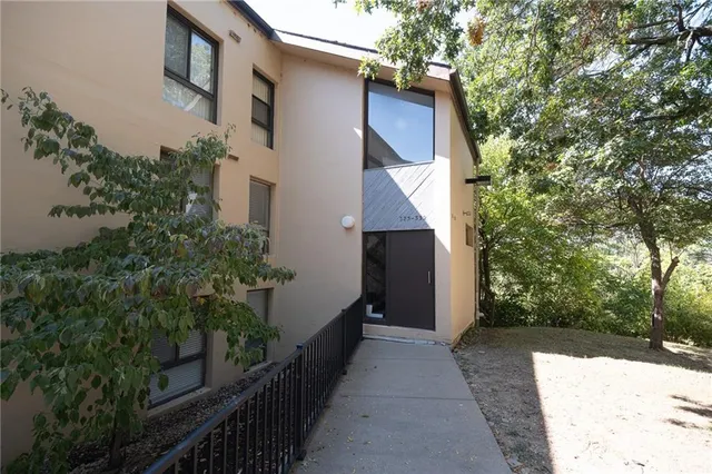 a view of a house with a yard and tree s