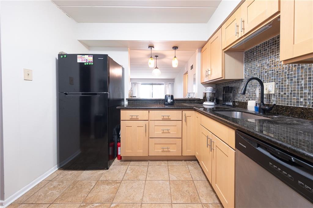 2034 Swallow Hill Road, Unit 326 Pittsburgh, PA 15220 - Photo 5 of 28 a kitchen with a refrigerator sink and cabinets