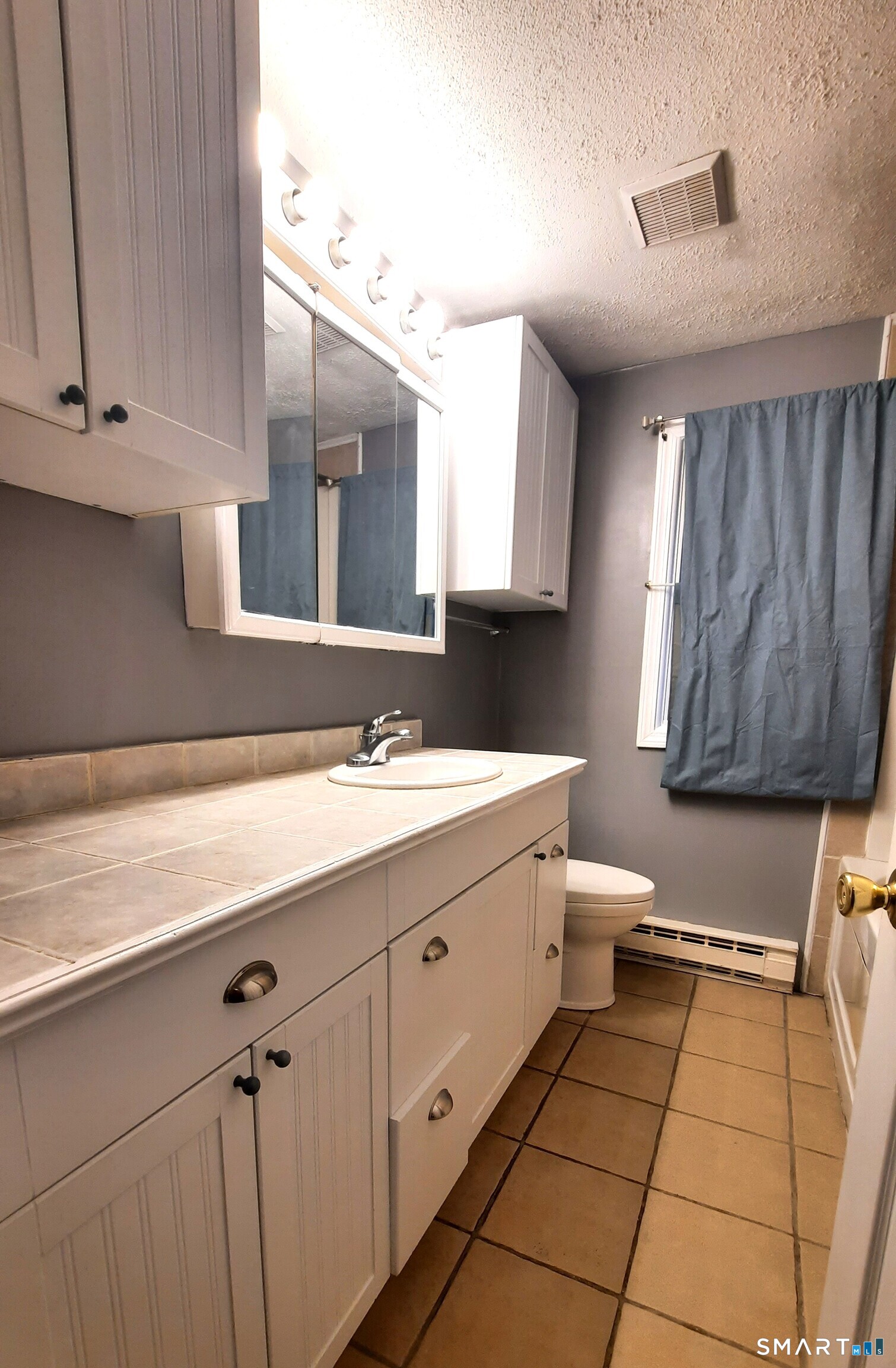 68 Viens Street Putnam, CT 06260 - Photo 12 of 20 a bathroom with a sink a toilet and mirror