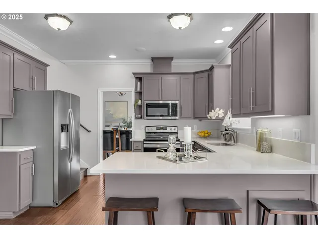 a dining room with furniture and wooden floor
