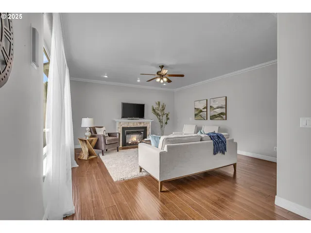 a living room with furniture a window and a potted plant
