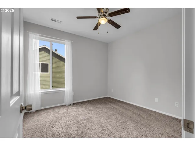 a spacious bathroom with a granite countertop sink a toilet and a mirror