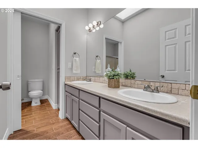 a hallway with wooden floor and cabinet