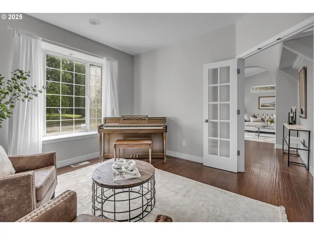 a living room with furniture potted plant and a window