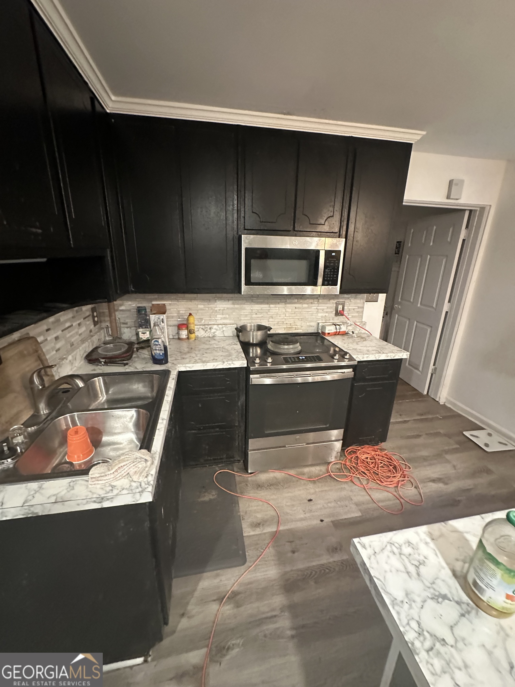307 Winding Stream Trail Southwest Conyers, GA 30094 - Photo 23 of 33 a kitchen with stainless steel appliances kitchen island granite countertop a refrigerator and a stove top oven