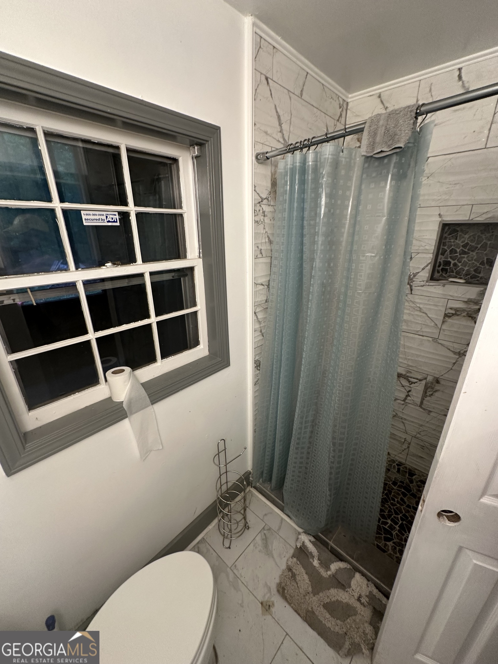 307 Winding Stream Trail Southwest Conyers, GA 30094 - Photo 28 of 33 a bathroom with a toilet and a shower