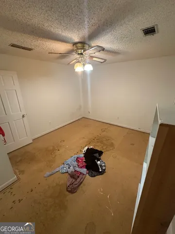 a view of a room with window and ceiling fan