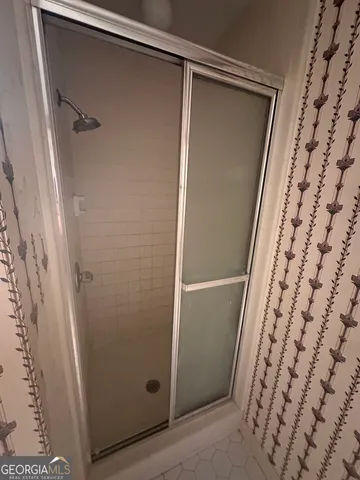 a bathroom with a shower and a sink