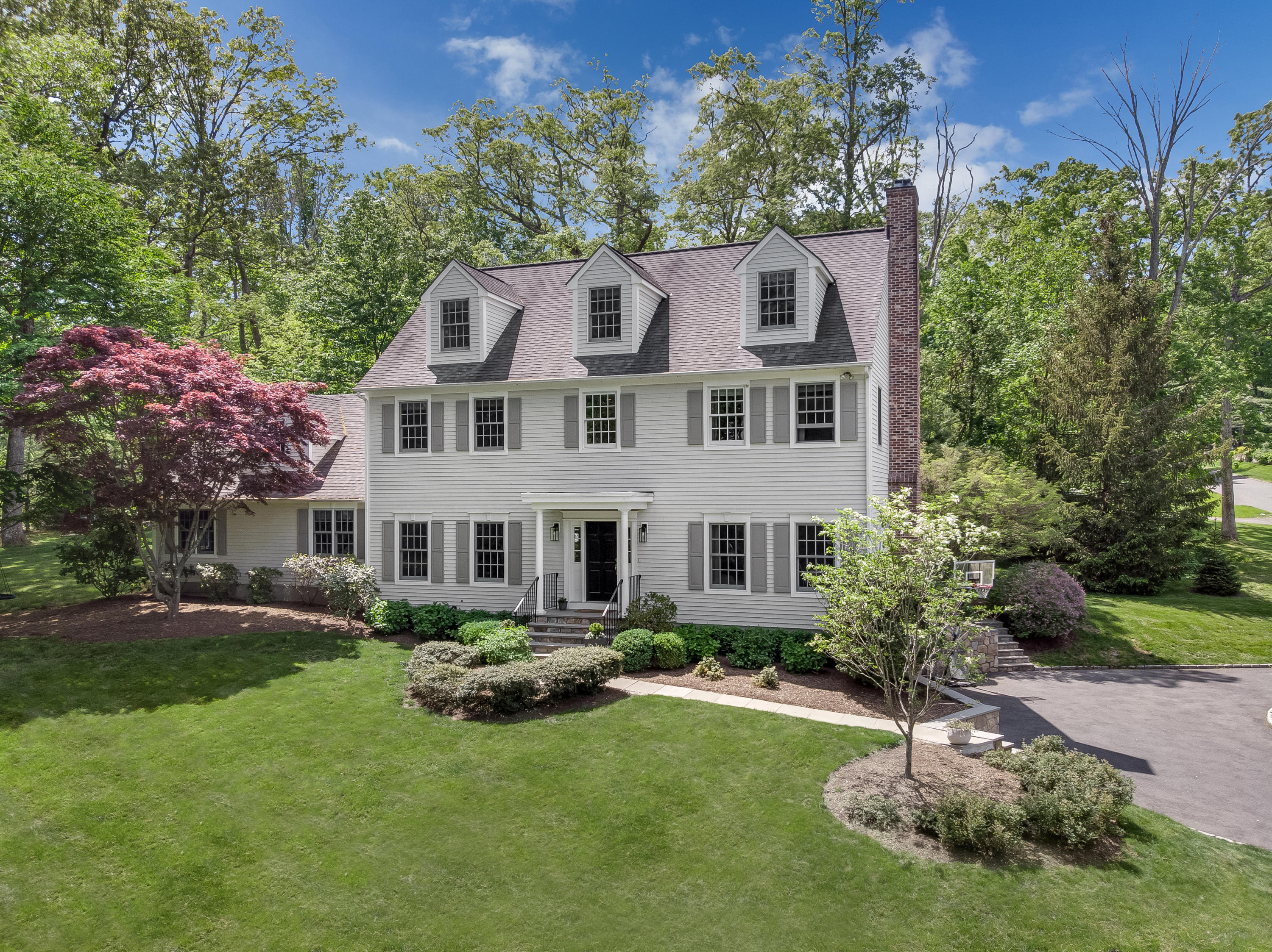 a front view of a house with a yard table and chairs