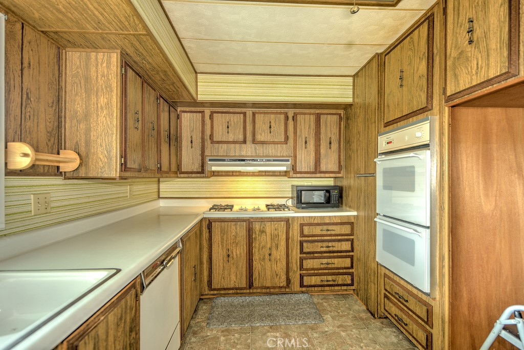 a kitchen with stainless steel appliances granite countertop a sink and cabinets