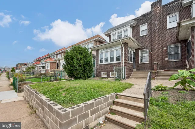 a front view of a house with a yard table and chairs