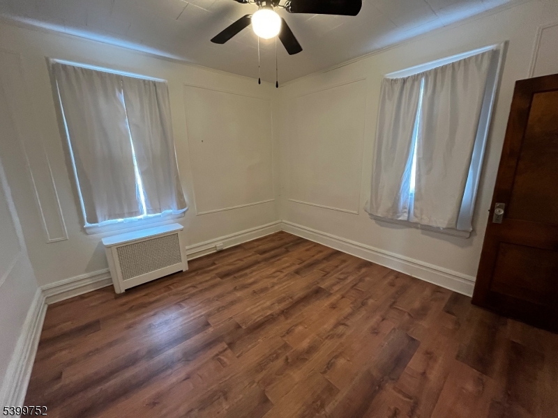 202 North 17th Street, Unit 1 Bloomfield, NJ 07003 - Photo 4 of 13 wooden floor in an empty room with a window