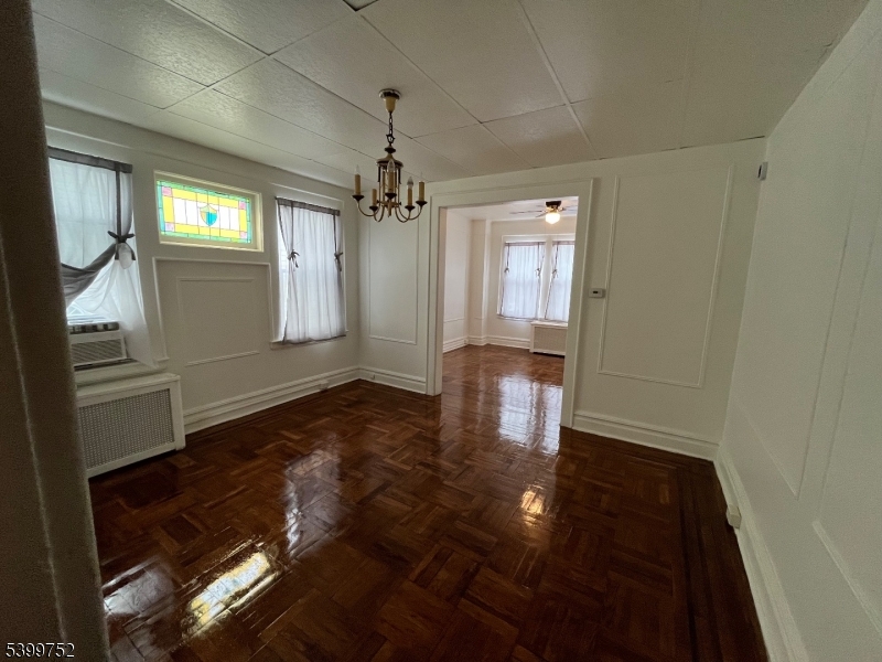 202 North 17th Street, Unit 1 Bloomfield, NJ 07003 - Photo 6 of 13 a view of empty room with wooden floor and window