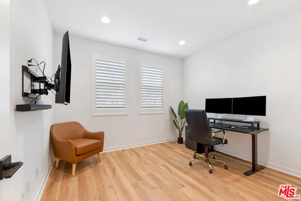 a workspace with furniture and wooden floor