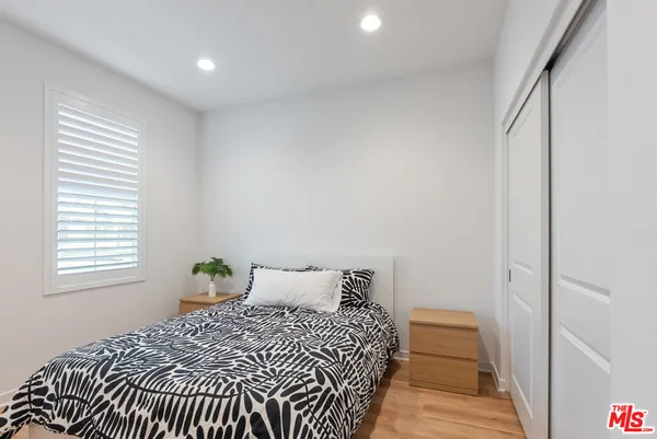 a bedroom with a bed and a window