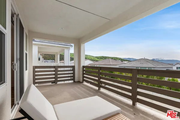 a view of a two chairs in the balcony