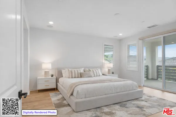 a bedroom with a large bed and a rug