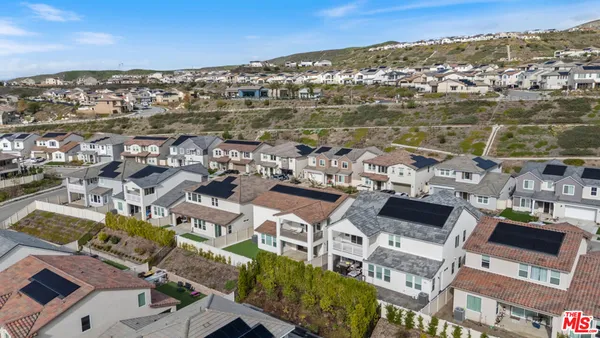an aerial view of residential building with parking