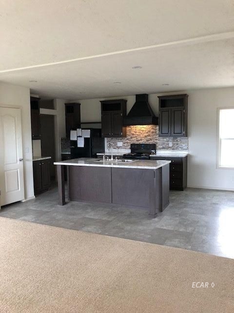 921 Spring Valley Parkway Spring Creek, NV 89815 - Photo 7 of 12 a kitchen with stainless steel appliances a sink and a stove top oven