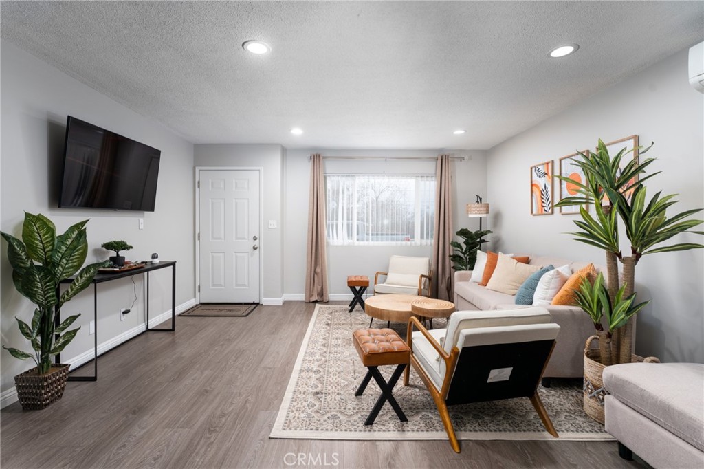 716 Orange Street Riverside, CA 92501 - Photo 4 of 28 a living room with furniture a flat screen tv and a potted plant