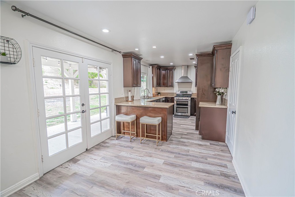 25535 Chisom Lane Stevenson Ranch, CA 91381 - Photo 12 of 37 a kitchen with a table chairs refrigerator and cabinets