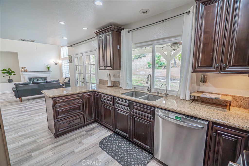 25535 Chisom Lane Stevenson Ranch, CA 91381 - Photo 15 of 37 a kitchen with stainless steel appliances granite countertop a sink stove and cabinets