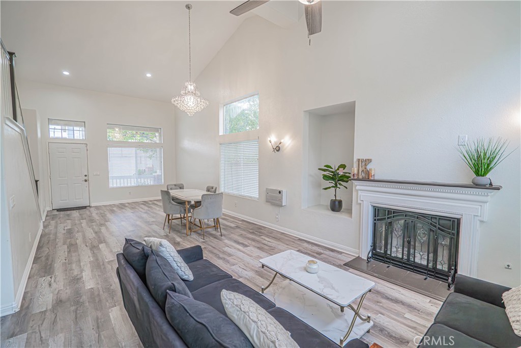 25535 Chisom Lane Stevenson Ranch, CA 91381 - Photo 18 of 37 a living room with furniture a fireplace and a potted plant
