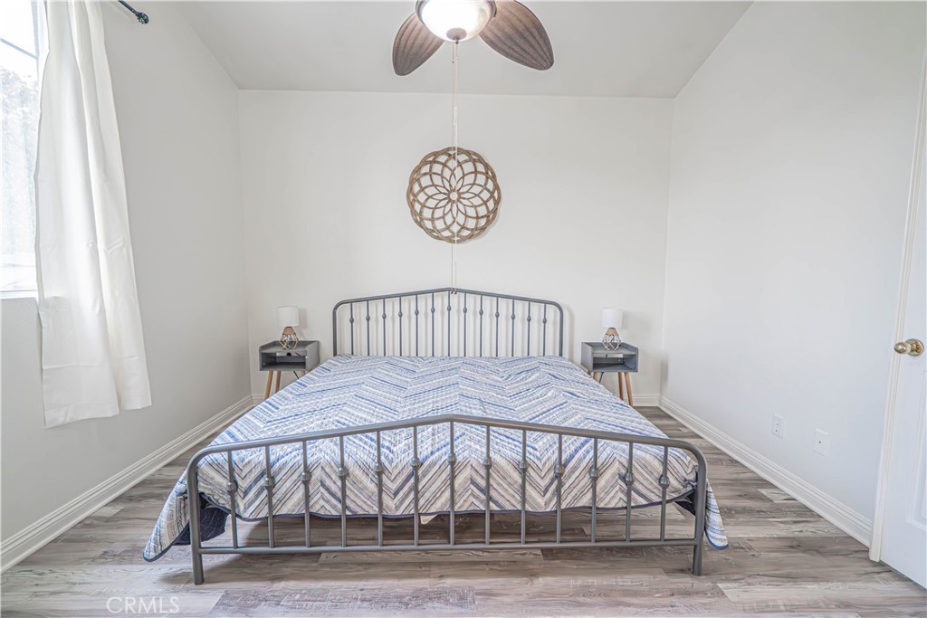 25535 Chisom Lane Stevenson Ranch, CA 91381 - Photo 24 of 37 a bedroom with a bed and a chandelier