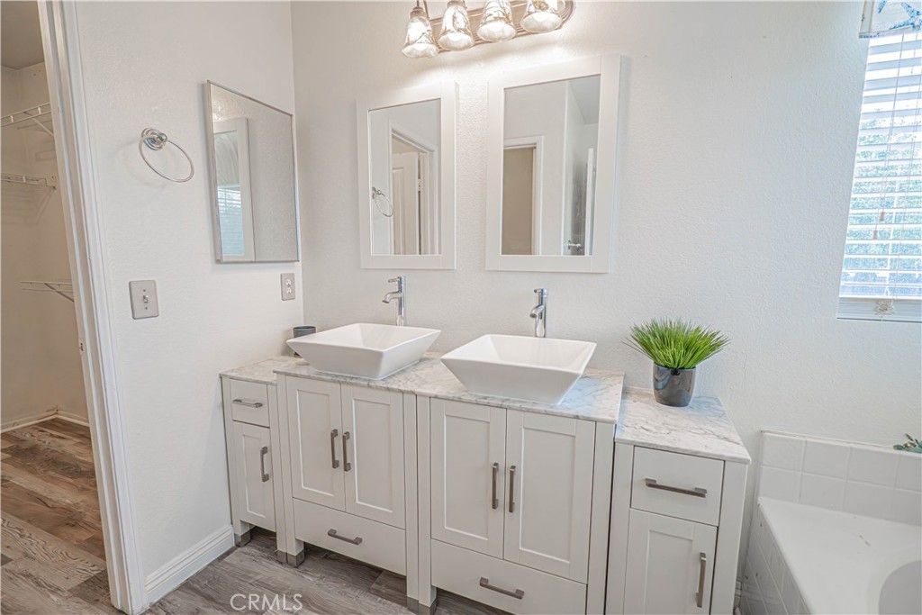 25535 Chisom Lane Stevenson Ranch, CA 91381 - Photo 25 of 37 a bathroom with a sink double vanity and a mirror