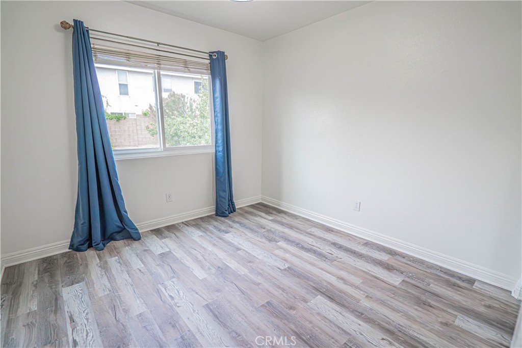 25535 Chisom Lane Stevenson Ranch, CA 91381 - Photo 29 of 37 an empty room with wooden floor and a window
