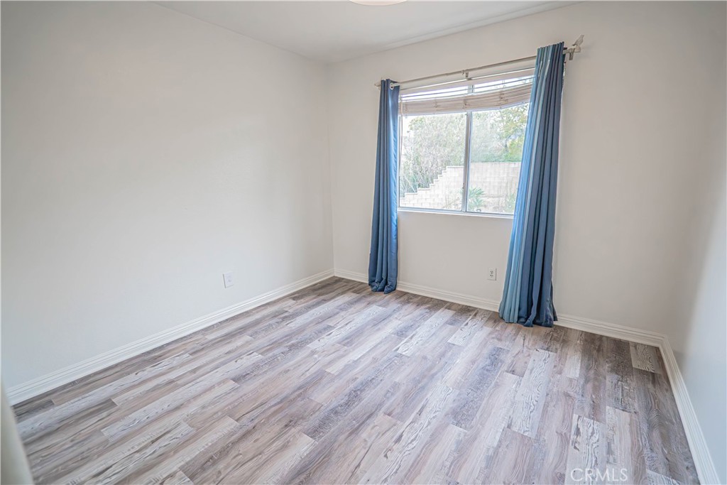 25535 Chisom Lane Stevenson Ranch, CA 91381 - Photo 30 of 37 a view of an empty room with wooden floor and a window