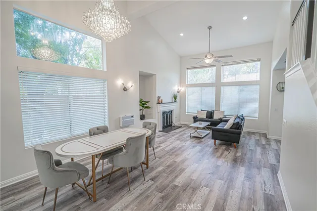 a view of a dining room with furniture wooden floor and a chandelier