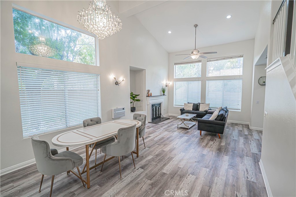 25535 Chisom Lane Stevenson Ranch, CA 91381 - Photo 9 of 37 a view of a dining room with furniture wooden floor and a chandelier