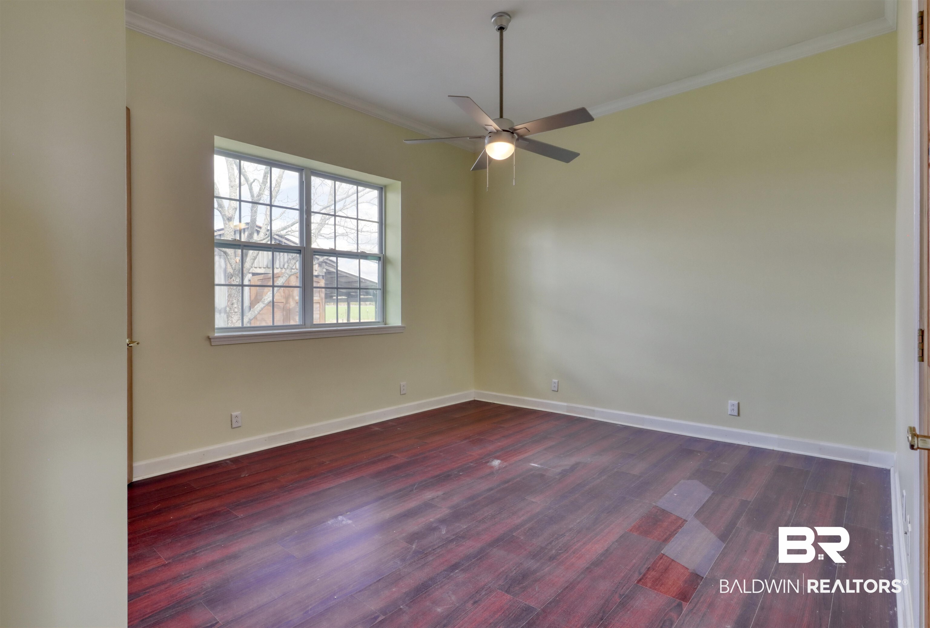 28461 Gardner Road Elberta, AL 36530 - Photo 11 of 46 Unfurnished room with ornamental molding, dark wood-style floors, and ceiling fan