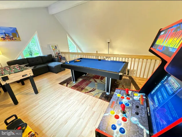 a living room with furniture and a baby crib