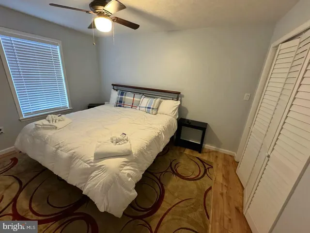 a bed sitting in a bedroom next to a window