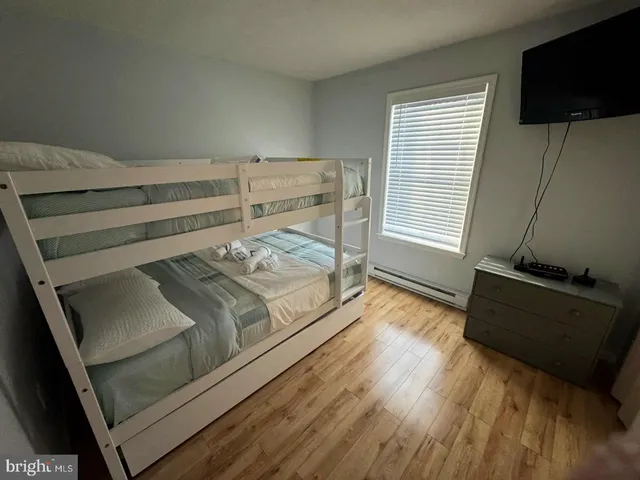 a bedroom with a bed and flat screen tv