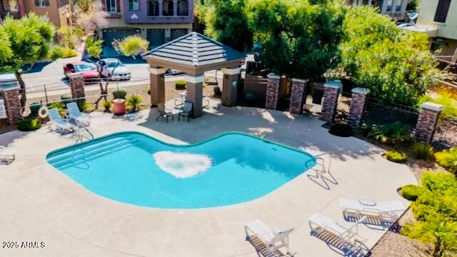 a view of yard with swimming pool and trees in the background