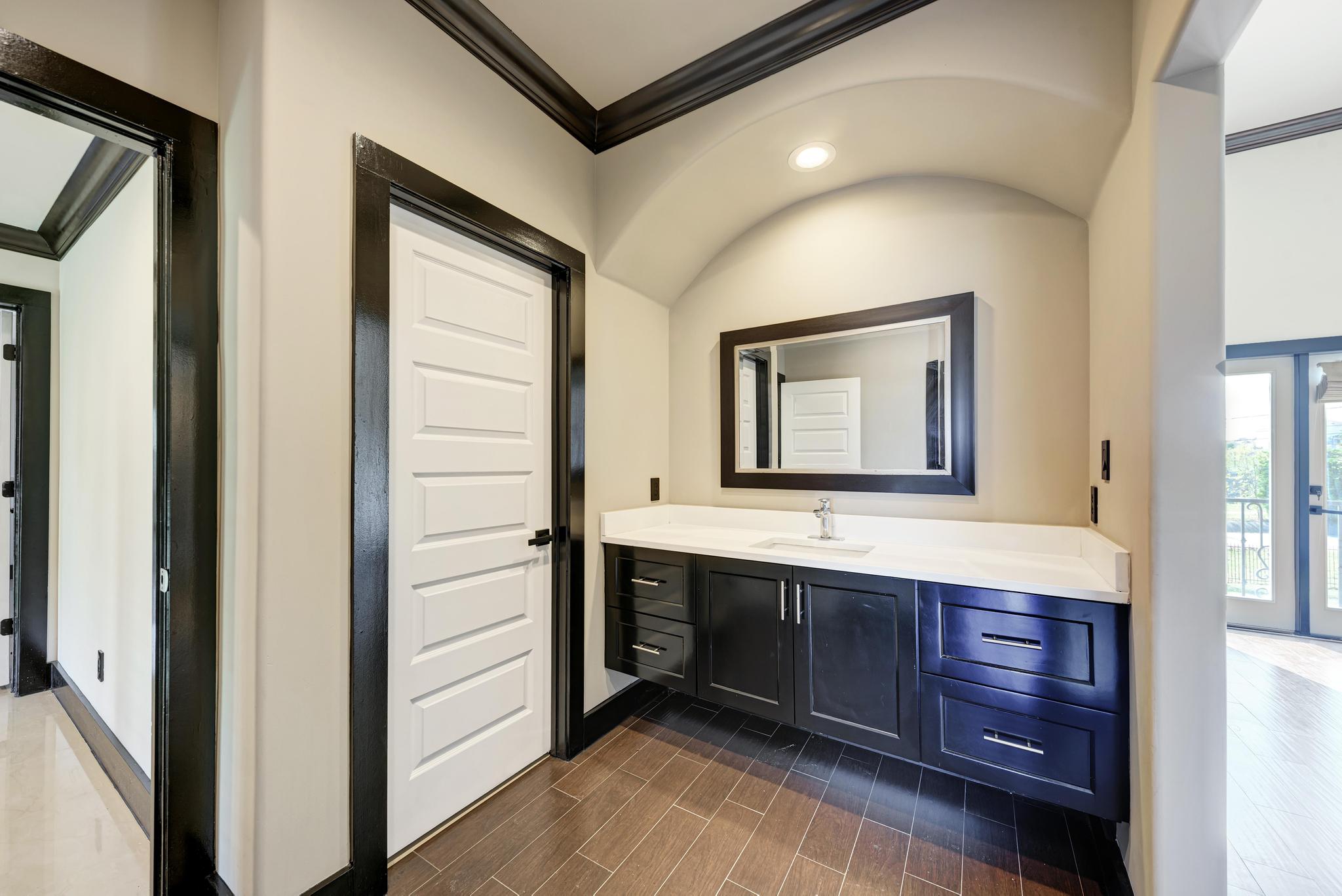 104 Spring Valley Street Hutto, TX 78634 - Photo 29 of 40 Bathroom with crown molding, vanity, and wood finish floors