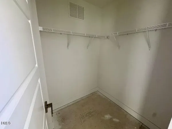 an empty room with a ceiling fan and window