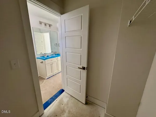 an empty room with a ceiling fan and window