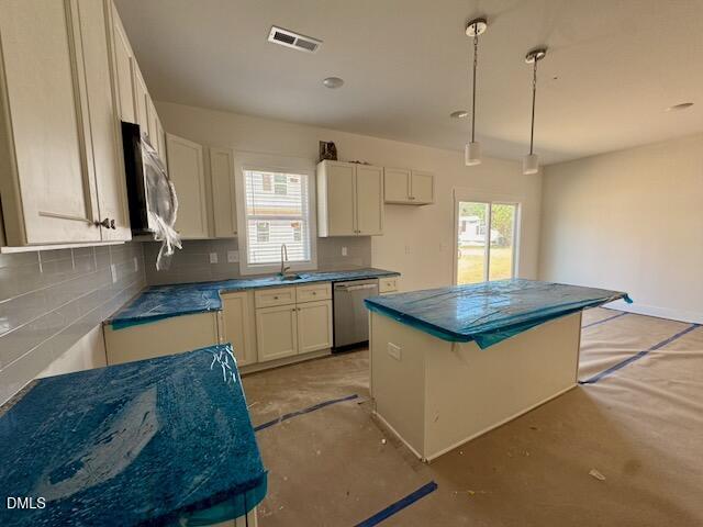 218 George Street, Unit A Four Oaks, NC 27524 - Photo 5 of 42 a kitchen with kitchen island granite countertop a stove a sink a center island and cabinets