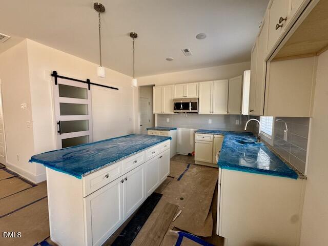 218 George Street, Unit A Four Oaks, NC 27524 - Photo 6 of 42 a kitchen with kitchen island sink stove and refrigerator