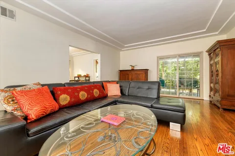 a bedroom with bed and wooden floor