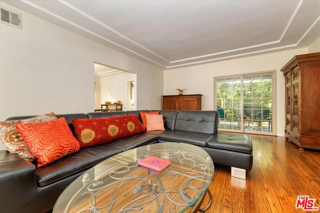 a bedroom with bed and wooden floor