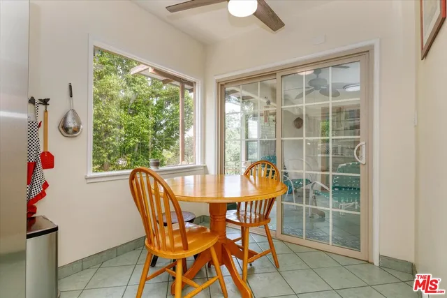 a view of a dining room with furniture and a window