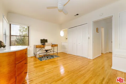 a work room with furniture and large windows