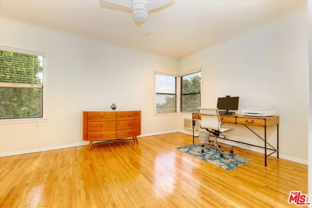 a room with wooden floor and glass door