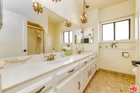 a bathroom with a sink a vanity and a mirror