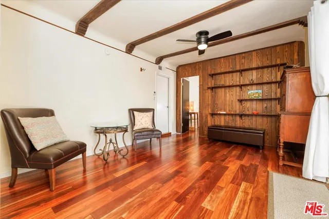 a view of a room with furniture and wooden floor